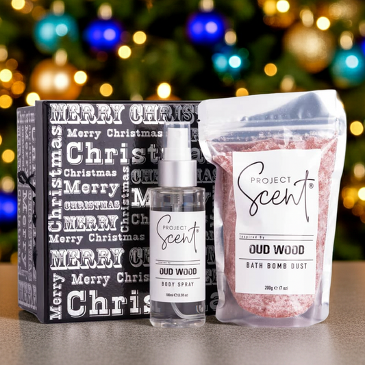 Project Scent products including a bottle and packaging with a Christmas tree in the background.