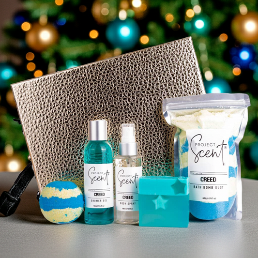 Project Scent products including Bath Dust, Shower Gel, and a bath bomb in front of a decorated Christmas tree.