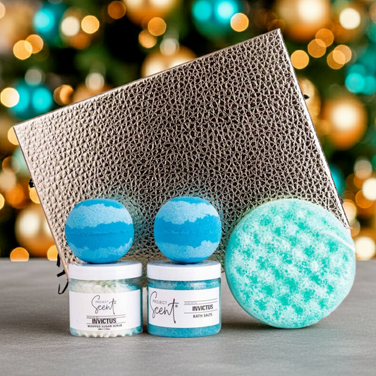 Two bath bombs with a gift box on a surface, Christmas tree in the background