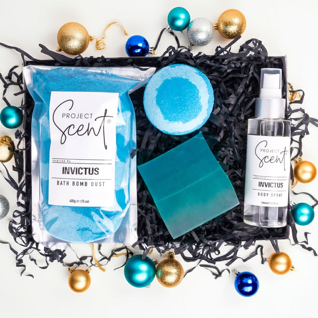 Project Scent Invictus bath bomb dust, soap bar, and body spray set with Christmas ornaments on a white background
