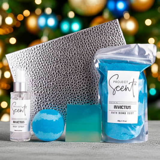 Project Scent Invictus product set with bath bomb, spray, and box against a Christmas tree background