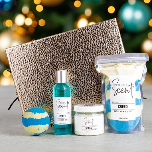 Project Scent products including a bath bomb, shower gel , and jar with a Christmas tree in the background.
