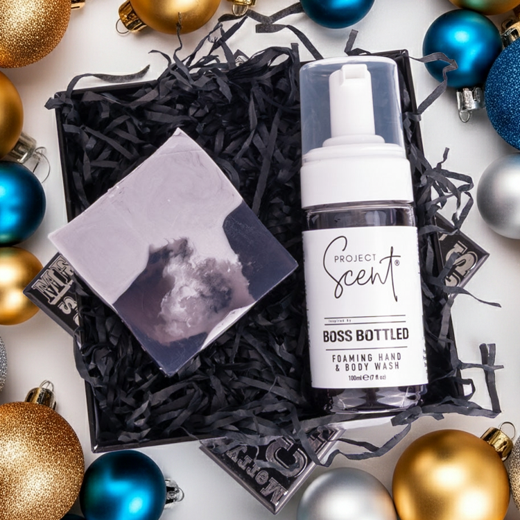 Project Scents gift set surrounded by colorful ornaments on a white background