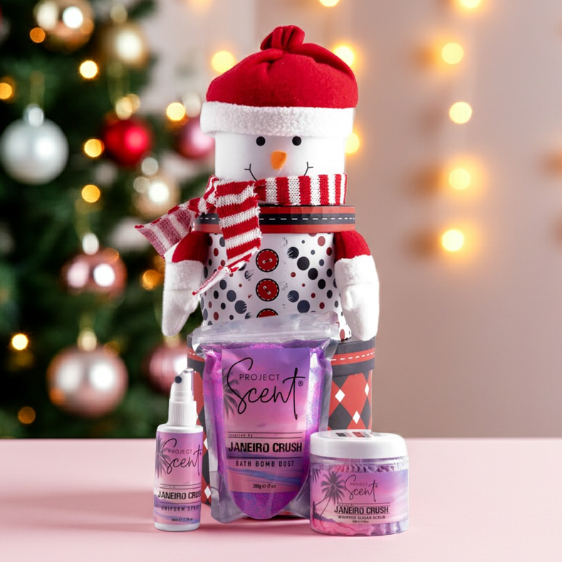 Snowman-shaped product display with Project Scent products against a Christmas tree and lights background