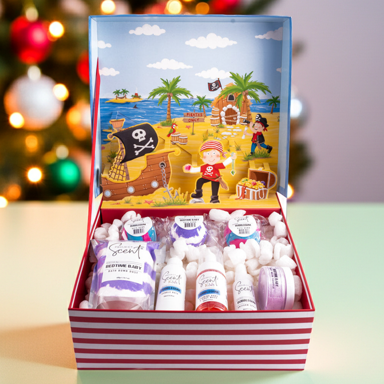 Gift set with pirate-themed packaging in front of a Christmas tree