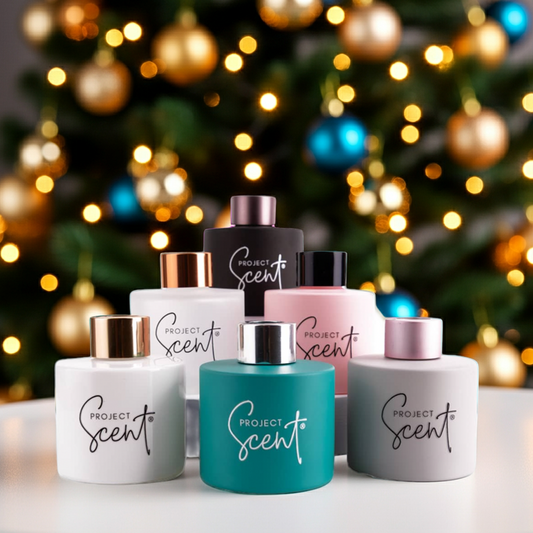 Collection of Project Scent products on a table with a decorated Christmas tree in the background