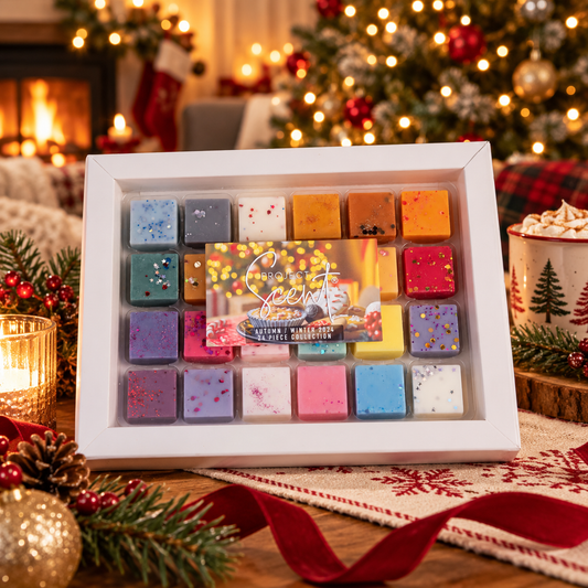 A boxed set of colorful bath salts displayed on a festive Christmas table. The white square frame contains multiple pastel and bright bath salts with decorative sprinkles, and a holiday-themed insert card is visible in the center.
