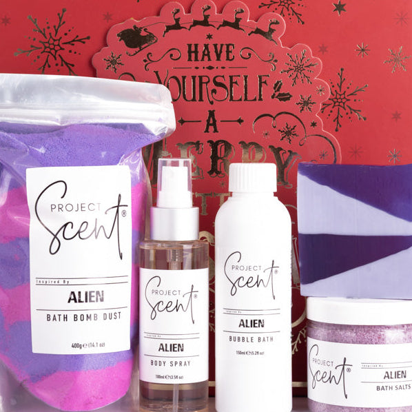 Set of Project Scents products including bath bomb dust, body spray, bubble bath, and bath salts in front of a decorative box.