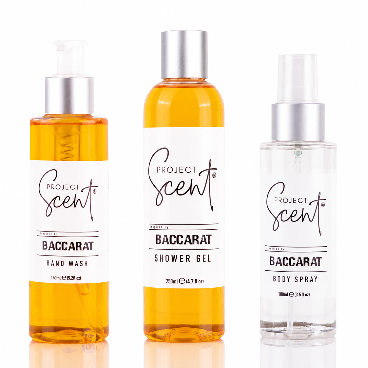 Three Project Scent Baccarat fragrance products on a white background: a hand wash bottle, a shower gel bottle, and a body spray bottle. The hand wash and shower gel contain amber-colored liquid, while the body spray is clear.