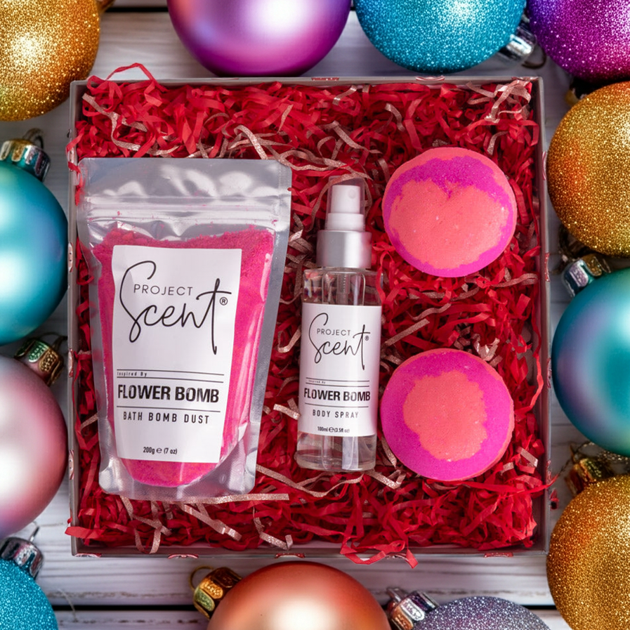 Flat lay of Flower Bomb Bath products with Christmas background.