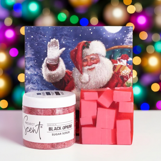 Christmas body care gift set in front of a Christmas tree. Includes handmade whipped sugar scrub and soap bar in festive gift packaging.