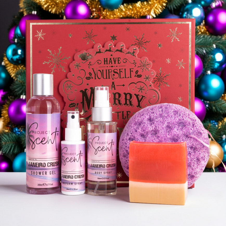 Luxury Body Care Gift Set displayed in front of a Christmas tree. Includes shower gel, soap sponge, body spray, uniform spray and soap bar — handmade, vegan and cruelty-free.