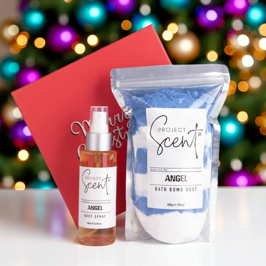 Christmas bath and body gift set in front of a Christmas tree. Includes handmade bath dust and body spray in festive gift packaging.