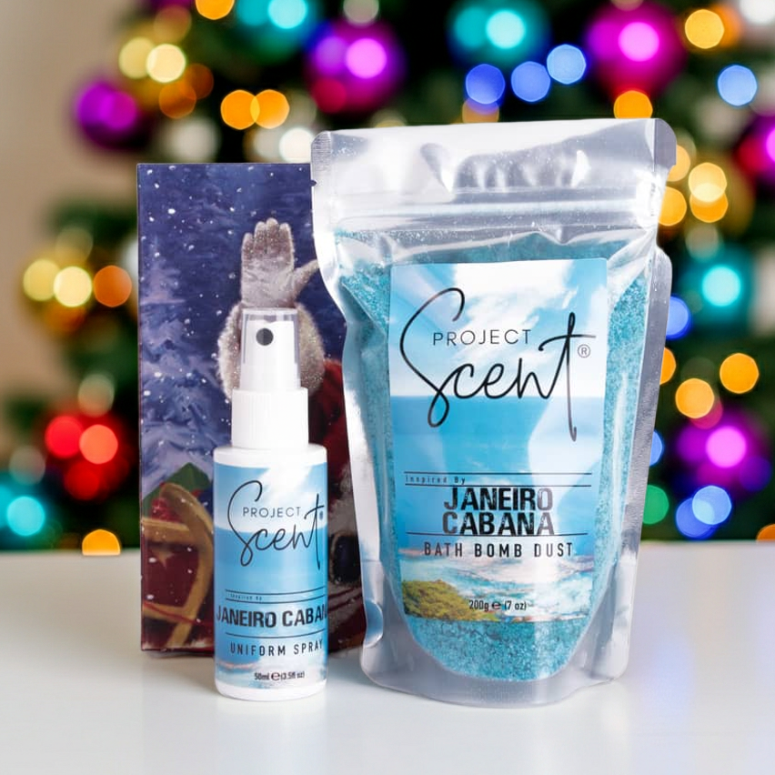 Christmas bath and fragrance gift set displayed in front of a Christmas tree. Includes handmade bath dust and uniform spray in festive packaging.