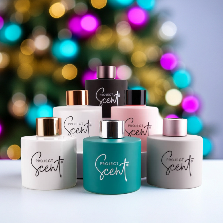 Christmas reed diffuser in front of a Christmas tree. Includes 7 fibre reeds and is available in festive scents like Gingerbread and Christmas Tree.